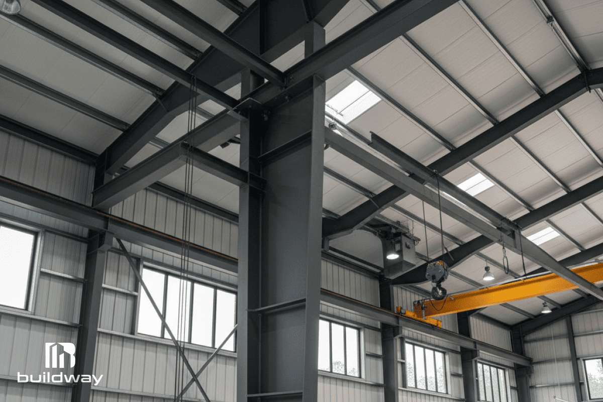 Close-up of the workshop’s steel framing and ceiling structure, showing the heavy-duty beams and bracing.