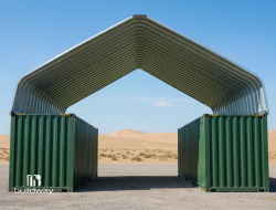 Open-frame industrial shelter made from two green steel containers with an arched metal roof, constructed by Buildway. Designed for durable outdoor use in industrial or remote environments.