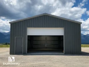 Front view of a gray cold-formed steel (CFS) building featuring a large white service door frame by Buildway.