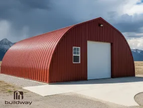 Red Quonset-style steel building by Buildway with an arched roof, white roll-up door, and side window, set on a concrete foundation under a cloudy sky.
