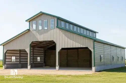 Large open-sided farm building with a raised roof and green trim, built by Buildway. Designed for storing hay, machinery, or livestock.